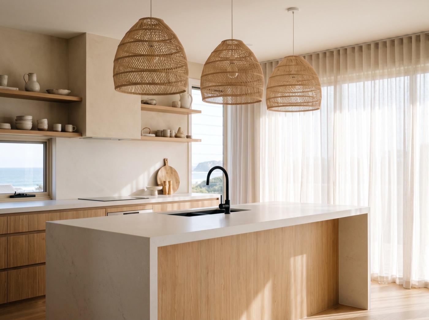 Modern coastal kitchen — light oak island, woven pendants, ocean light